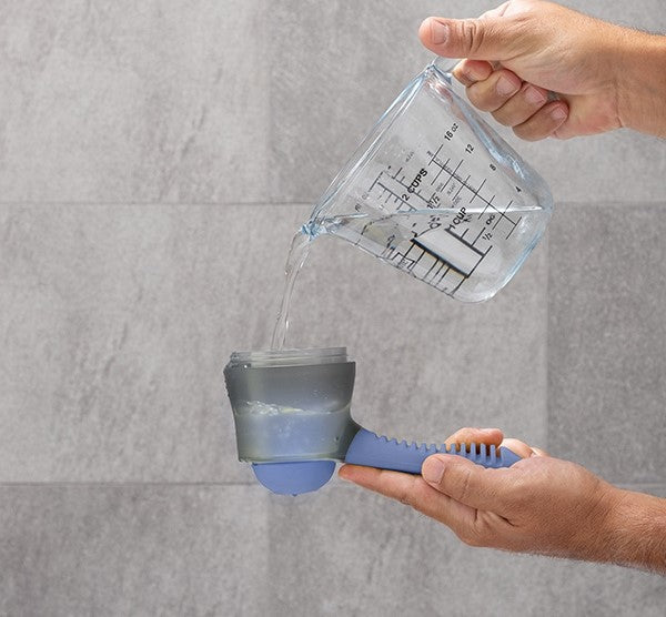 Minimalist bath brush with container on a bathroom counter